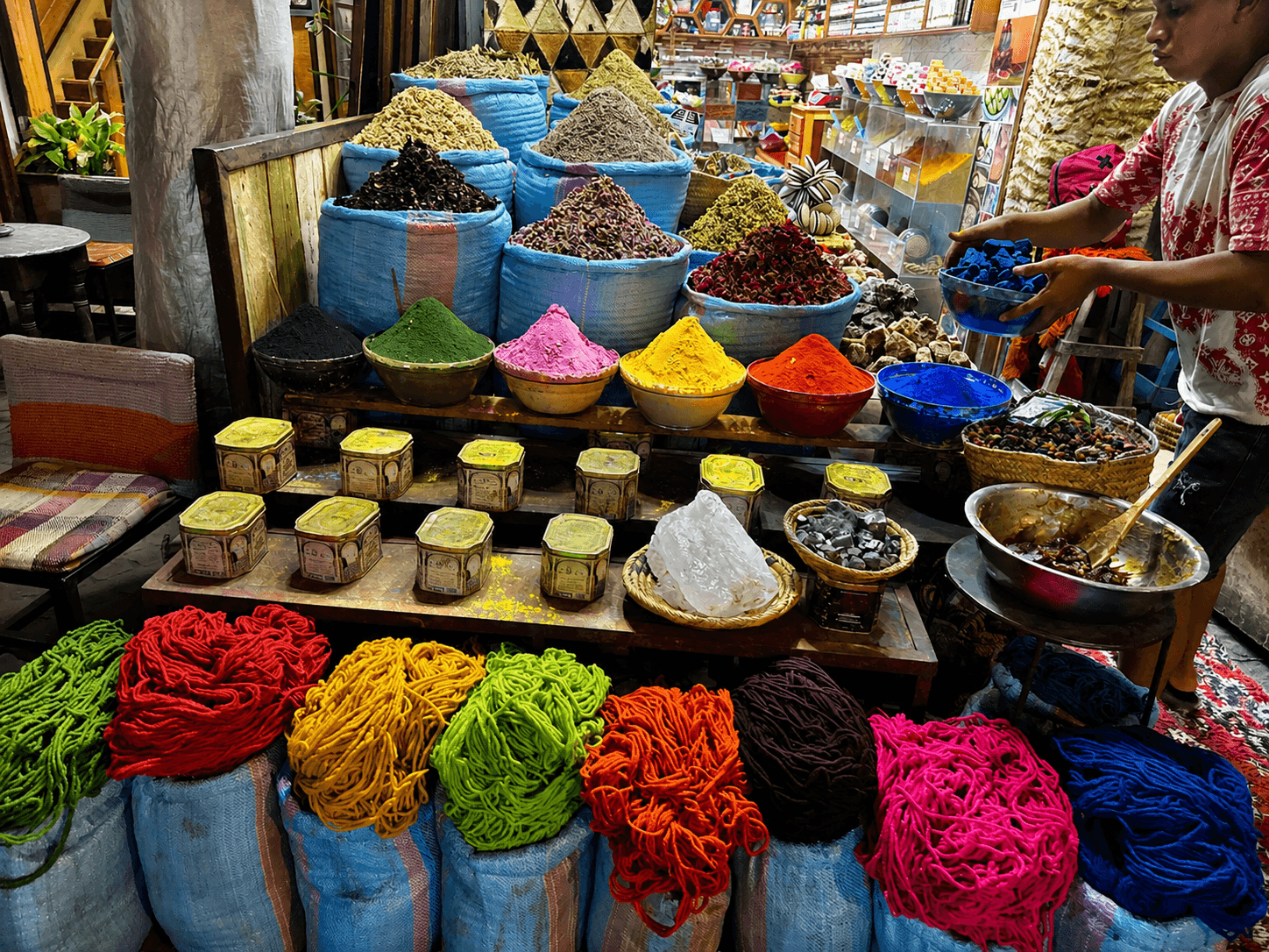 Vibrant indoor market filled with colourful yarns and spices