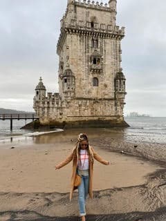 Solo traveler in front of Belem Tower in Portugal